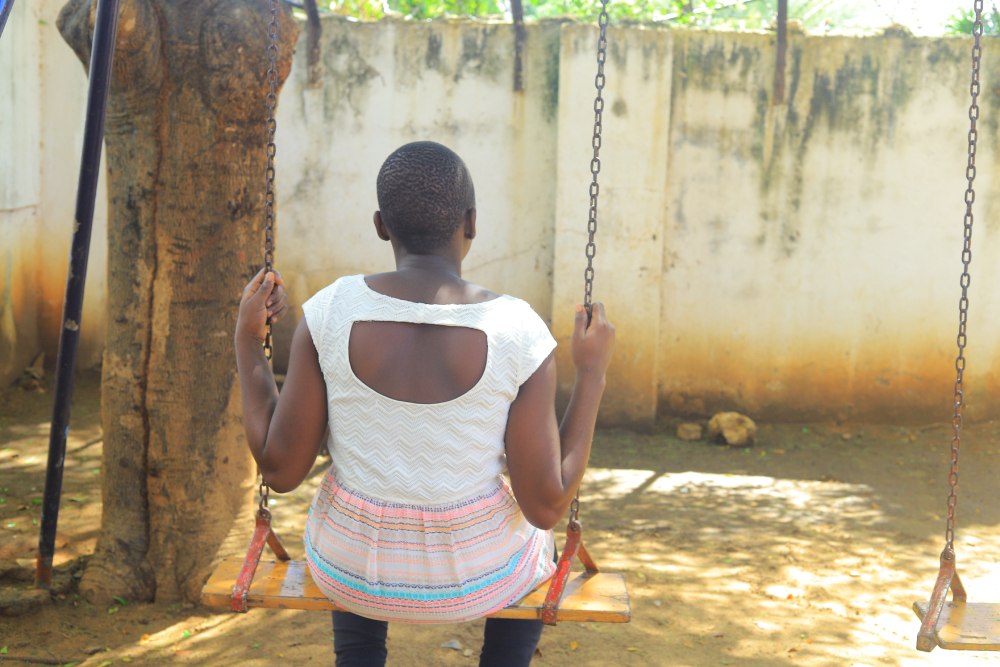 A girl sits alone on a swing at Mahali Pa Usalama, a safe haven run by Catholic sisters for survivors of sexual exploitation. (GSR photo/Doreen Ajiambo)