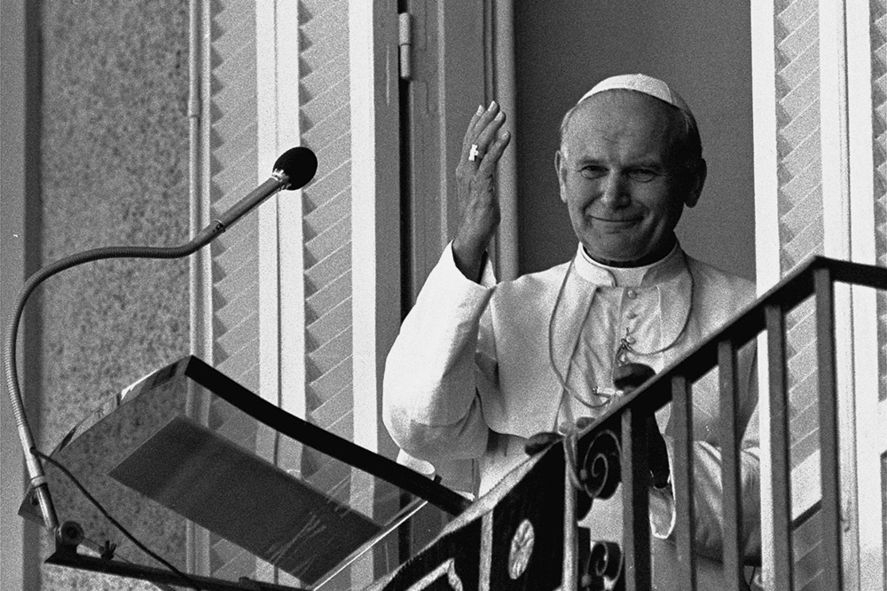 A smiling Pope John Paul II waves to the faithful from the balcony of his summer residence, Castel Gandolfo, in this small town overlooking Lake Albano, south of Rome, Sept. 4, 1983. (AP/Massimo Sambucetti)