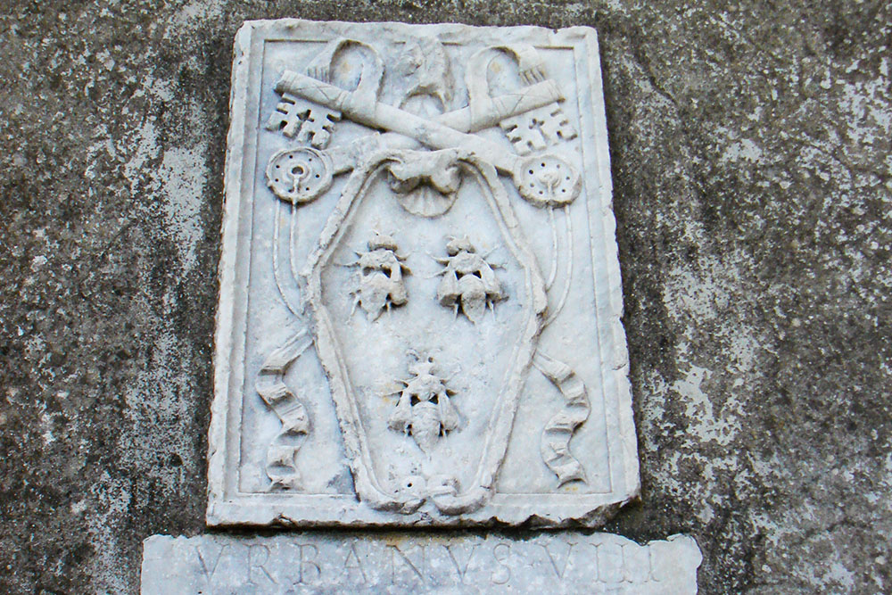 The papal coat of arms of Pope Urban VIII is seen on a wall in Castel Gandolfo, Italy. (Wikimedia Commons/Stefano Bolognini)