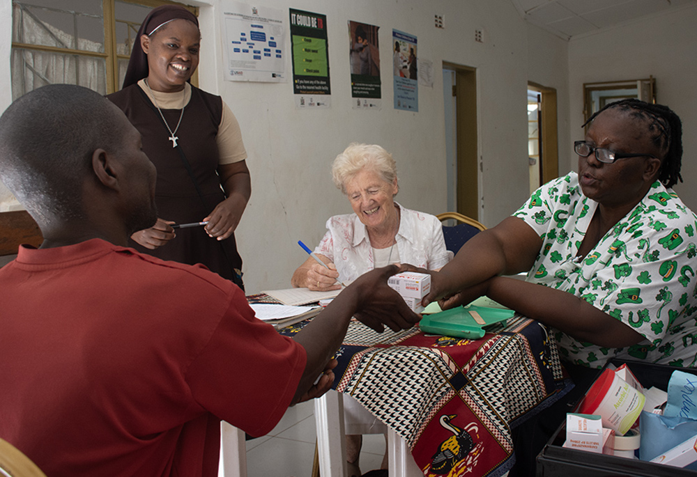 Sr. Mary Courtney interacts with patients receiving medication from the St. Francis Community Integrated Care Programme in Livingstone, Zambia. (Derrick Silimina)