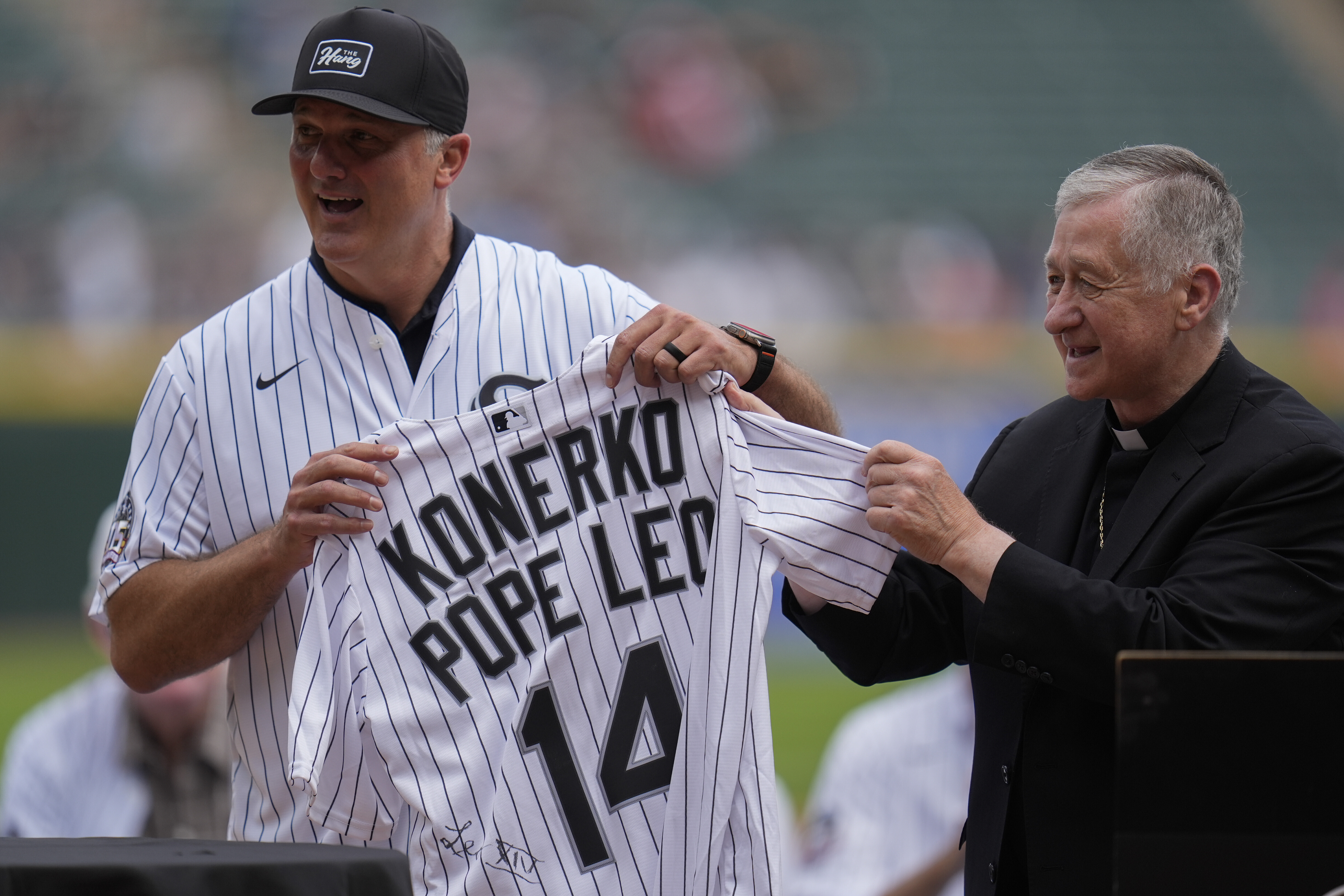Cupic to Konerko Cardinal Blase Cupich, right, presents former White Sox player Paul Konerko with a jersey signed by Pope Leo XIV during a ceremony honoring the 2005 World Series Champions before a baseball game between the Cleveland Guardians and Chicago White Sox, Saturday, July 12, 2025, in Chicago. (AP Photo/Erin Hooley)