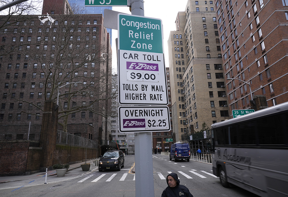 Signs advising drivers of congestion pricing tolls are displayed near the exit of the Lincoln Tunnel in New York on Feb. 19, 2025. (AP photo/Seth Wenig)