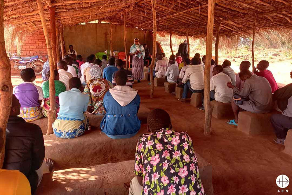Under a thatched roof chapel, Catholics in a rural Mozambican village gather for catechism and community outreach led by local religious sisters. (Courtesy of Aid to the Church in Need)