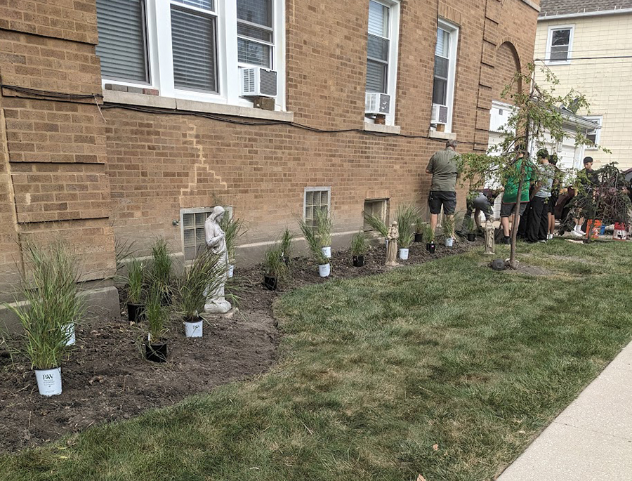 Members of Voces Fieles Comunitarias Contra la Opresión (Faithful Community Voices Against Oppression) have worked on phytoremediation projects, such as planting rain gardens, at churches and homes in Cicero, Illinois. They are pictured with their work on Aug. 24, 2024. (Courtesy of Delia Barajas)