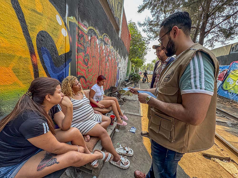 Workers from CAFEMIN, a shelter for women and families run by Josephine sisters in Mexico City, check in on the welfare of migrants living in a camp near the train tracks. Some were weighing returning home since they said they can't head north to the U.S., and Mexico makes it difficult for them to obtain documents to work and survive. (GSR photo/Rhina Guidos)
