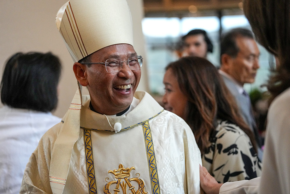 Bishop Michael Pham smiles as he's greeted by attendees before his installation Mass on July 17, 2025, at St. Thérèse of Carmel Parish in San Diego. (NCR photo/Chris Stone)