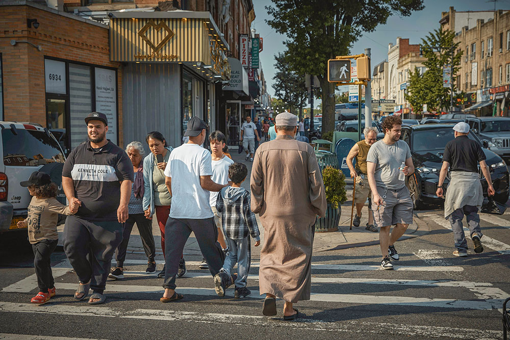 Pedestrians cross the street in the Bay Ridge neighborhood of Brooklyn, New York, June 5, 2025. (AP/Andres Kudacki)
