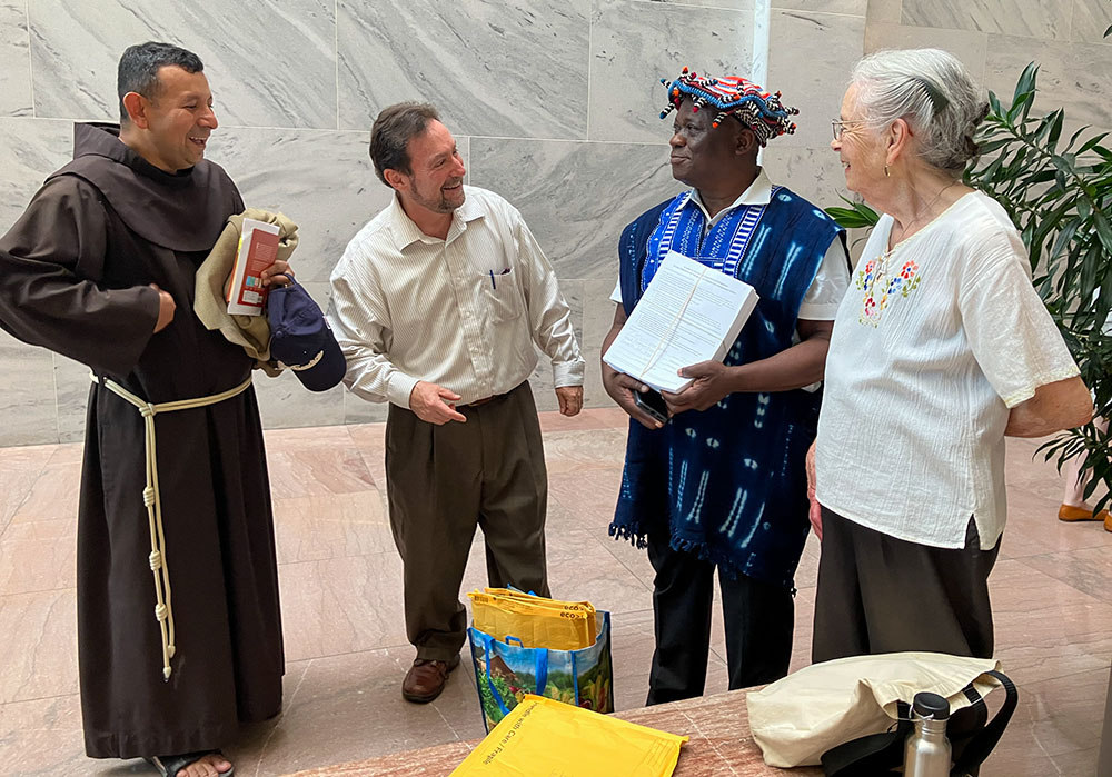 Franciscan Fr. Juan de la Cruz Turcios, Russ Testa, Dominique Njinkeu and Mary Rein prepare to deliver letters (held by Njinkeu) to members of Congress June 26, 2025, seeking protection for immigrants, on behalf of St. Camillus Parish in Silver Spring, Maryland. (NCR photo/Patricia Zapor)