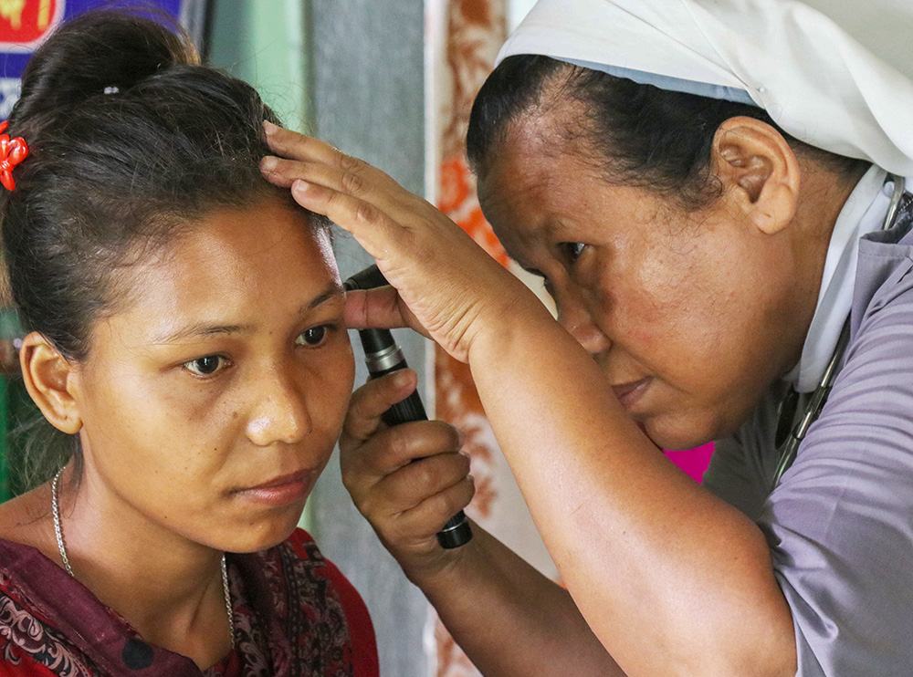 Salesian Sr. Baptista Rema treats pregnant women and other patients in need daily. Pictured is an Indigenous woman who came to the hospital to seek treatment for her ears. (GSR photo/Stephan Uttom Rozario)