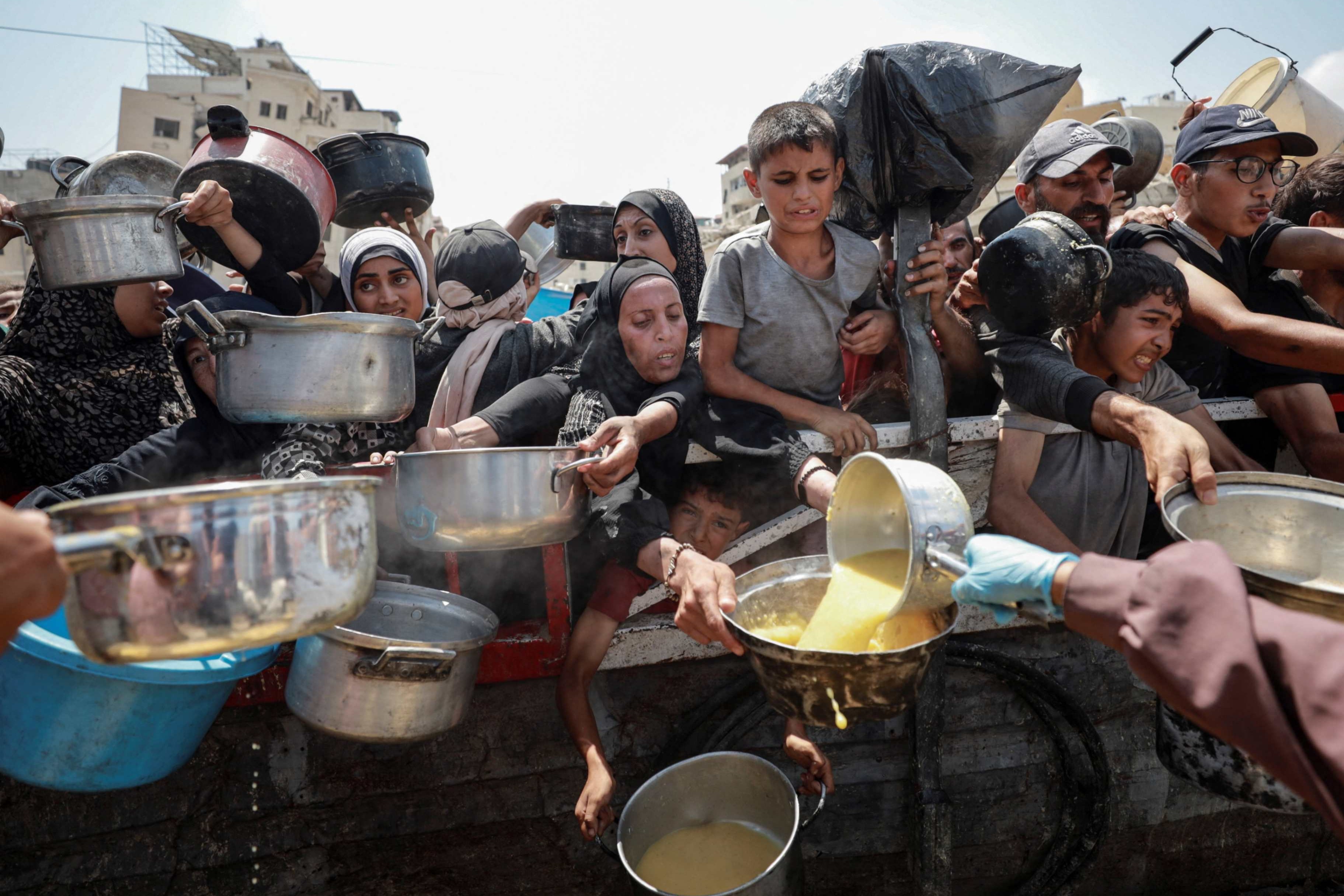 Palestinians receive food from a charity kitchen in Gaza City July 28, 2025, amid a hunger crisis. Jennifer Poidatz, acting representative for Catholic Relief Services in Jerusalem, the West Bank and Gaza, told OSV News July 31 that Gaza-based CRS staff are working to bring high-calorie, high-protein food to residents amid destroyed agricultural lands, fuel and energy deficits, high prices, danger and disease. (OSV News/Reuters/Khamis Al-Rifi)