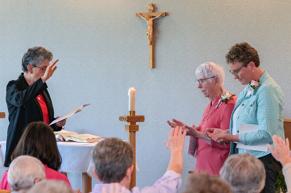 Sr. Vicky Larson (right) receives a community blessing.