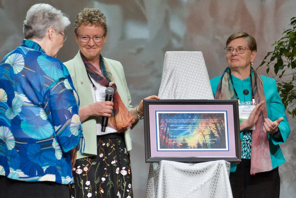 Sr. Vicky Larson presents award.