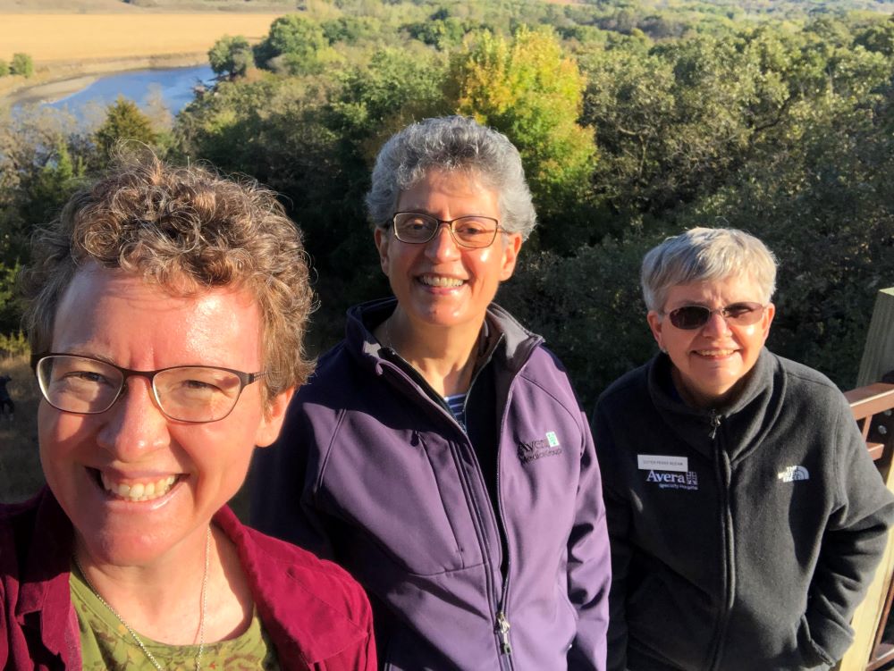 Sr. Vicky Larson poses during a hike with two other women. 