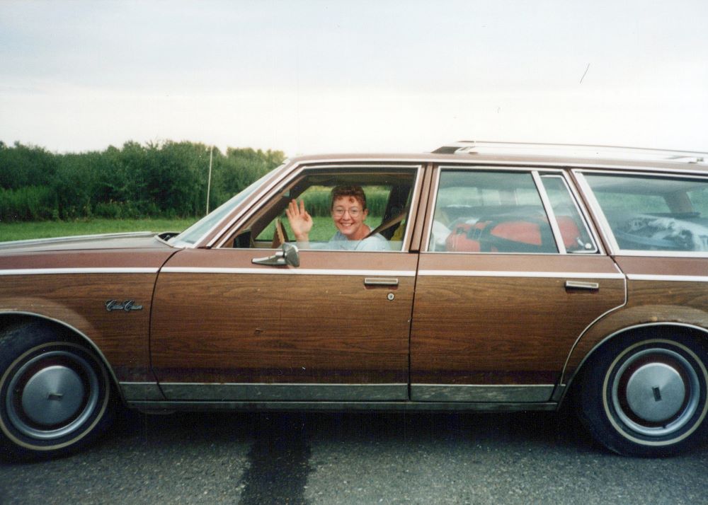 Sr. Vicky Larson driving station wagon