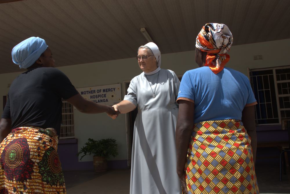 Sr. Jeremia Mrowiec greets two women at hospice.