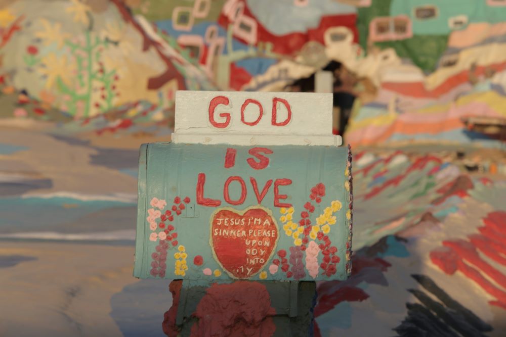 Artwork says "God is Love."