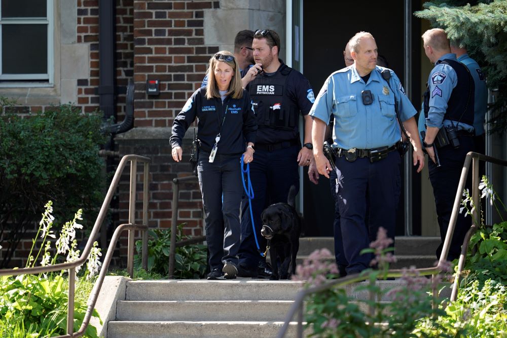 Law enforcement officers gather outside the Annunciation Catholic School as they respond to a mass shooting Aug. 27 in Minneapolis.