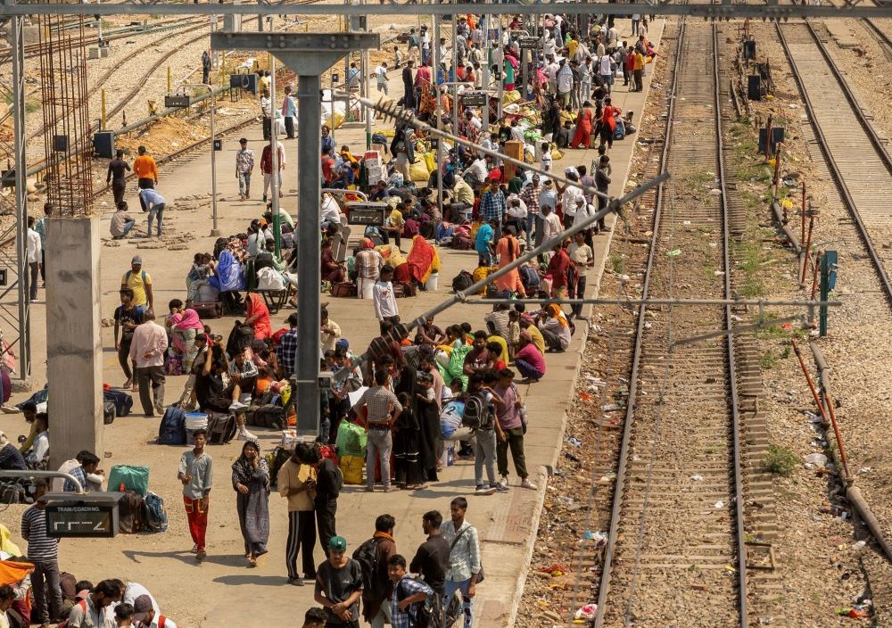 people on train platform in India