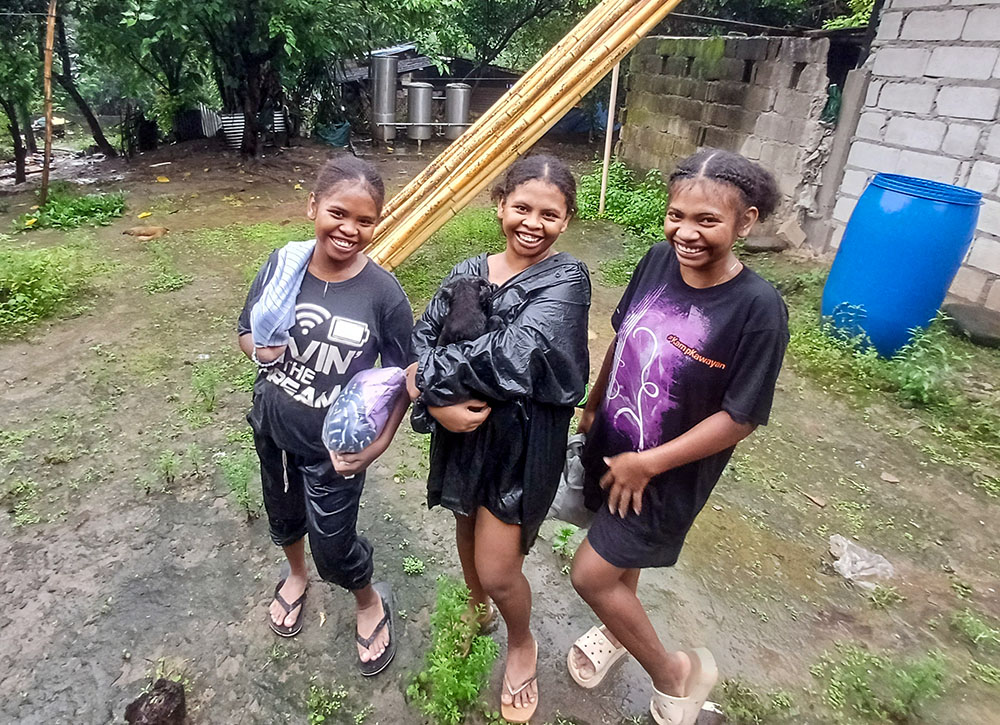 Young Aetas of Sitio Camachile in Nabuclod, Floridablanca, Pampanga, the Philippines, head home from a farm on a rainy afternoon. (Oliver Samson)