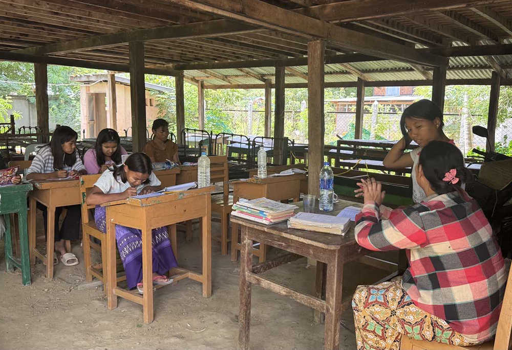 A teacher guides school lessons for girls at St. Joseph's Orphanage center in Zaw Gyi village, Archdiocese of Mandalay. The orphanage currently serves about 20 orphan girls, mostly from the Kachin, Chin and Bamar ethnic tribes. (John Zaw )
