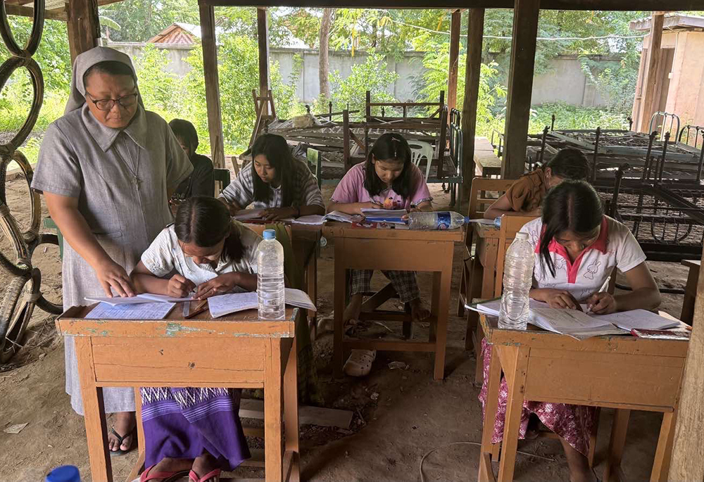 Sr. Roselyn Kay Mg checks on girls studying at the St. Joseph's Orphanage in Zaw Gyi village, Archdiocese of Mandalay, on June 25. Mg is in charge of the orphanage and serves as the superior of the Sisters of St. Joseph of the Apparition. (John Zaw)