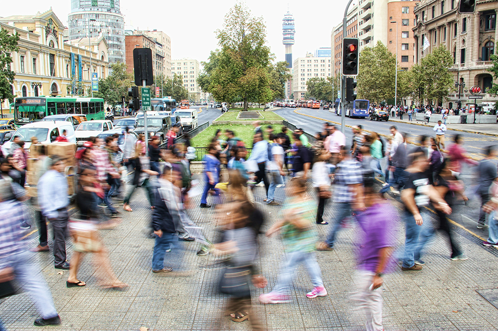 People walking in a busy street intersection (Unsplash/Mauro Mora)