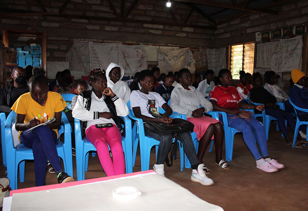 Teenage girls are trained on children's rights by a Safe Space officer from Igembe South. Safe Space organizes community sensitization forums on children's and human rights, as well as gender-based violence issues. (Courtesy of Doreen Mukami)