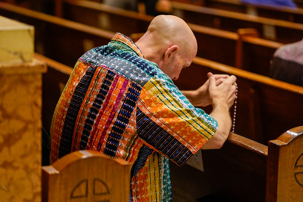 A worshipper prays prior to the annual "Pre-Pride Festive Mass" at St. Francis of Assisi Church in New York City June 29, 2024. The liturgy, hosted by the parish's LGBT+ ministry, is traditionally celebrated on the eve of the city's Pride parade. (OSV News/Gregory A. Shemitz)