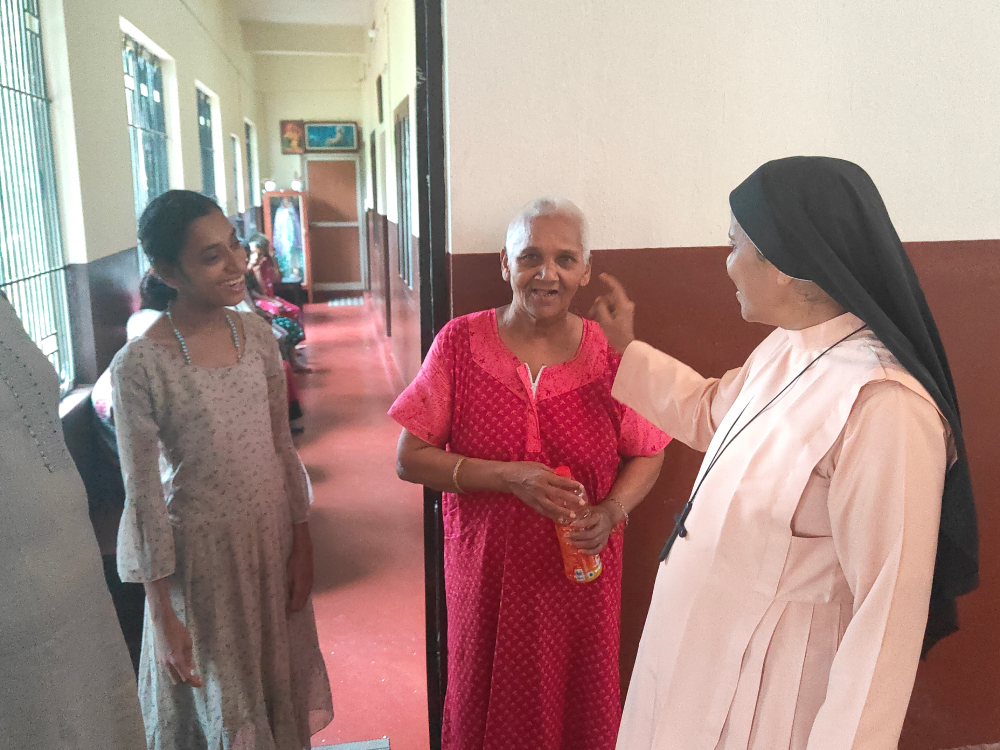 Bethany Sr. Bhagya Thalichirayil interacts with "Didi" (red), a senior resident, and Sujatha (left), the youngest resident of Asha Bhavan, a home for disabled and abandoned women at Ichilampady, a village in Karnataka state, southwestern India. (Thomas Scaria)