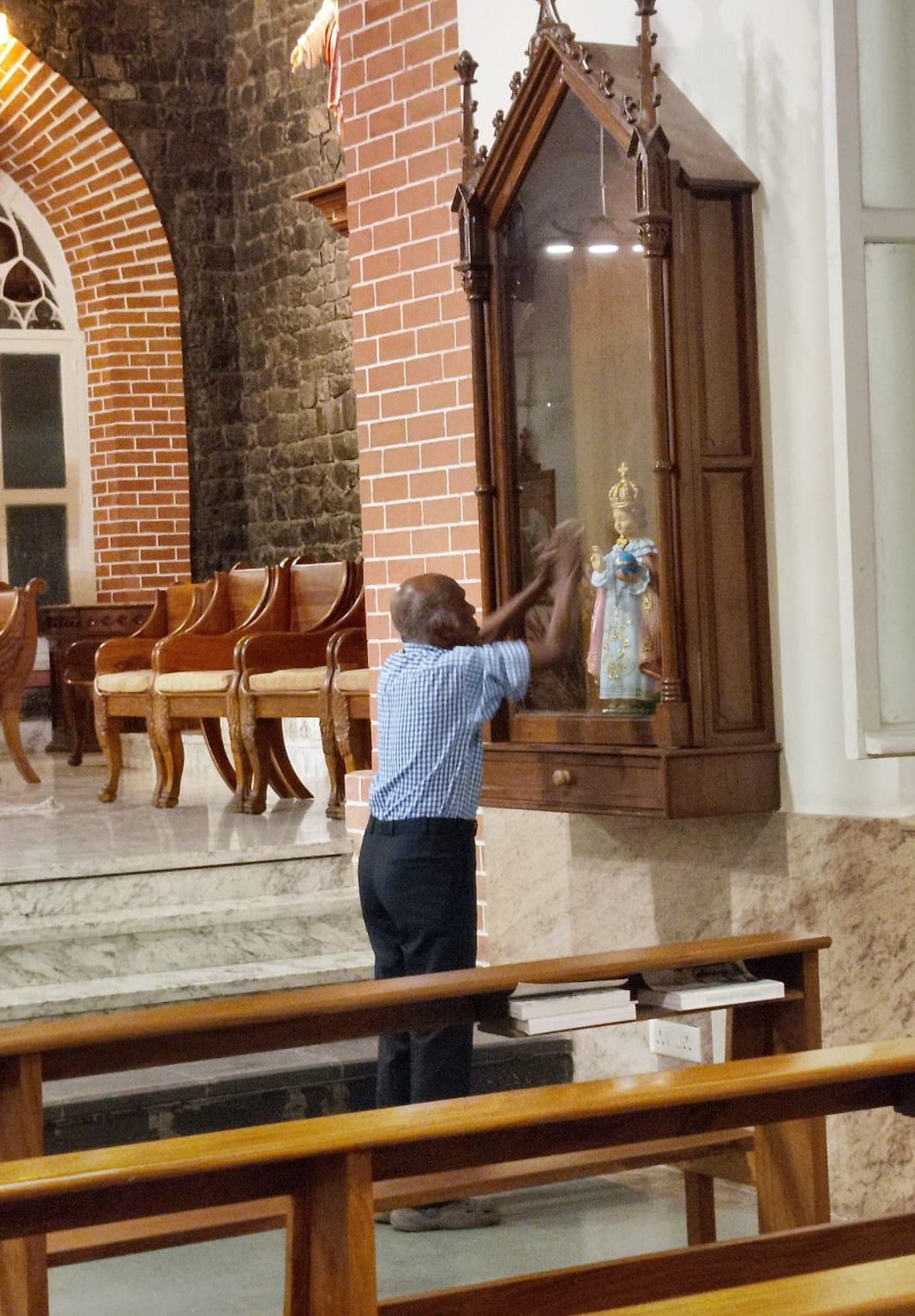 Faith is lived in churches, temples, and mosques with an intimate and personal intensity, as shown by this example of the popular devotion of a man praying at St. Francis Xavier Catholic Parish in Pune. (Consuelo Vélez)