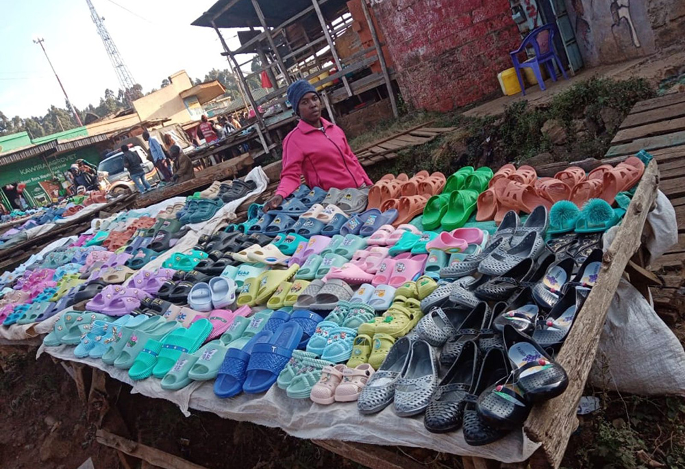 Judy Mukami, a beneficiary of the Brighten Her Future project, now sells Crocs at the Kangeta market. (Mourine Achieng)
