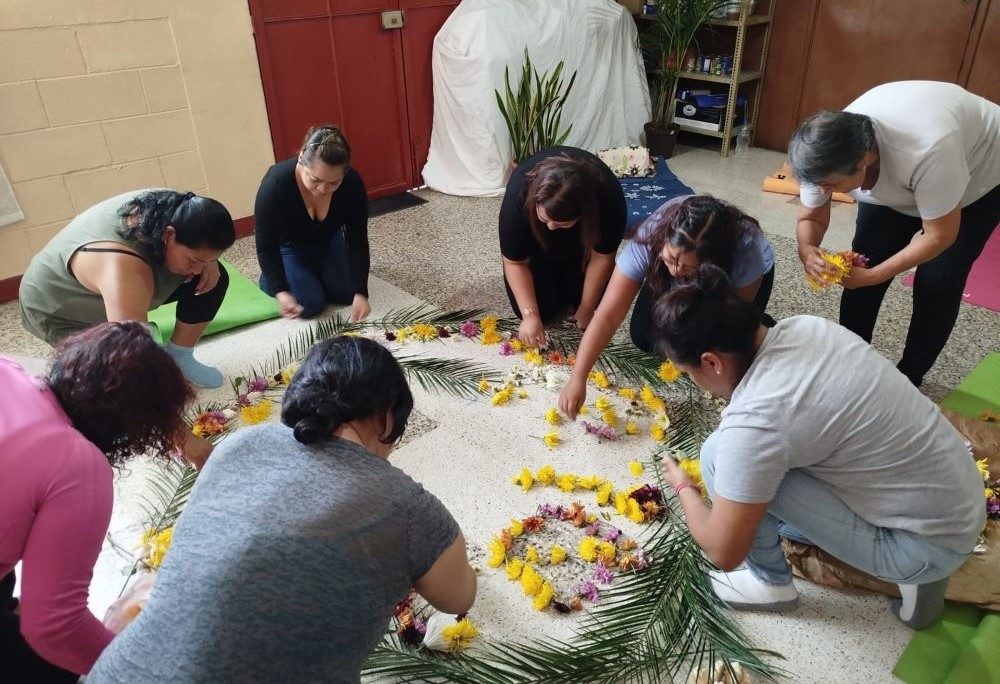 Women create a flower mandala as a symbol of gratitude.