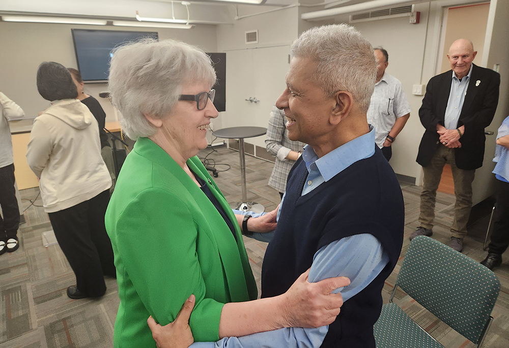 Fr. Rohan Dominic, right, NGO representative of the Claretians at the United Nations, greets Sr. Winifred Doherty at Doherty's retirement party in April 2024. (GSR photo/Chris Herlinger)