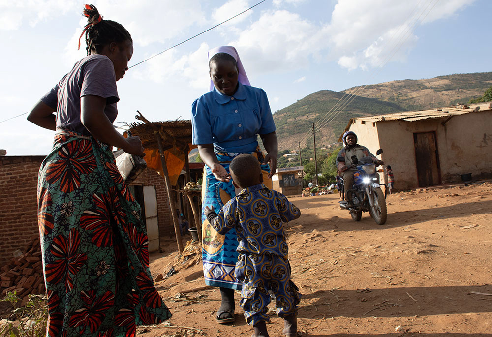 Elias Tembo and his mother, Catherine Mwale are pictured with Sr. Christabel Kazembe. Tembo and Mwale are beneficiaries of the Strengthening the Capacity of Religious Women in Early Childhood Development. The project trains mothers on early childhood nutrition, including the importance of locally sourced foods and complementary feeding practices. (Derrick Silimina)