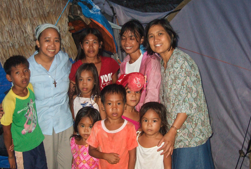 Verbum Dei Missionary Sr. Luisa Mesina, second from left, with the people of Guiuan, Eastern Samar, in the Philippines, after the devastation of the super typhoon of November 2013. (Courtesy of Luisa Mesina)