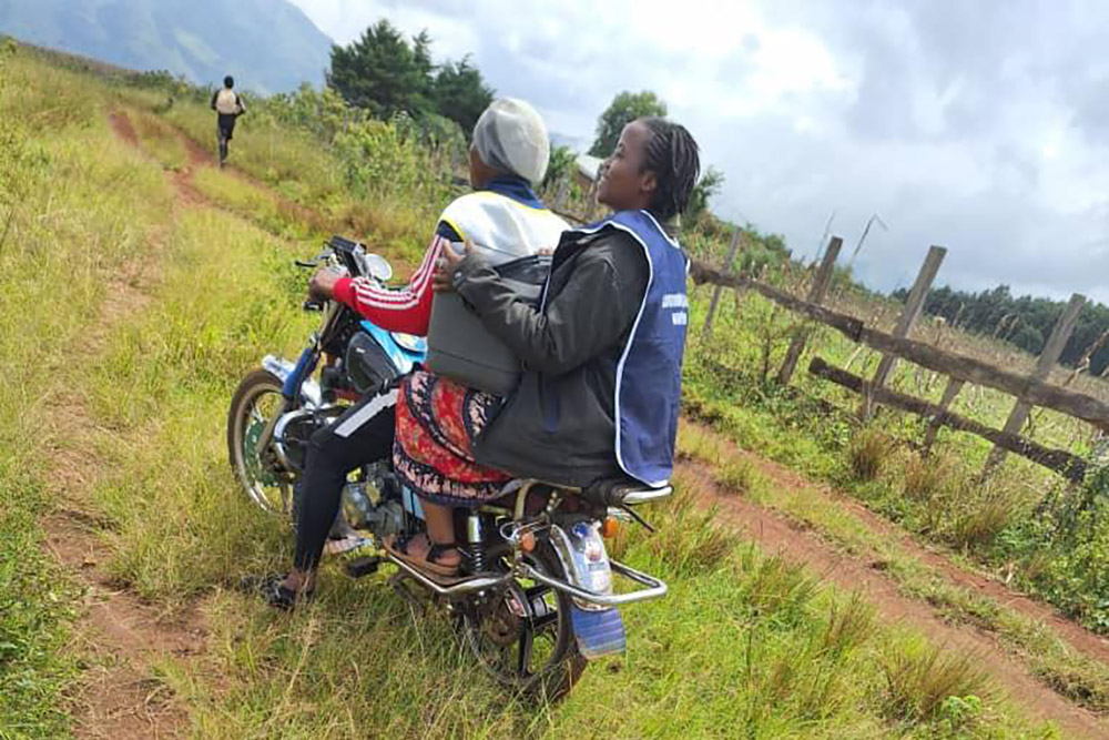 Because the roads are in poor condition or nearly nonexistent, Sr. Veronica Nange Ngeh and local residents in Cameroon primarily use motorbikes for transportation. She rode 25 kilometers to administer vaccinations to children in a remote area. (Courtesy of Veronica Nange Ngeh)