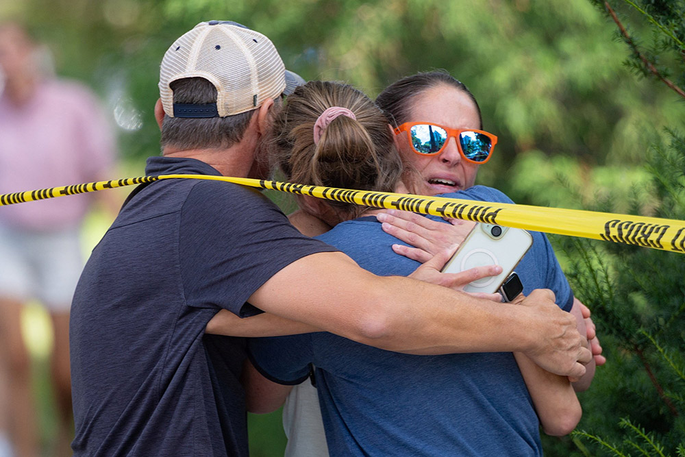 Families and loved ones reunite following a shooting at Annunciation Church in Minneapolis Aug. 27, 2025. A gunman opened fire with a rifle into the church during Mass for Annunciation School's first week of classes, killing two children and wounding 21 people, most of them children. (OSV News/Reuters/Ben Brewer)