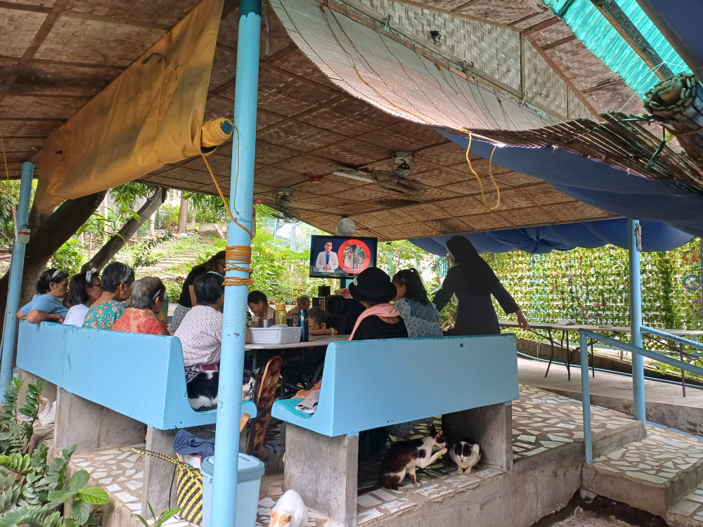 Residents of the Mary Mother of Mercy Home for the Elderly and Abandoned watch television in their kiosk in San Pedro, Laguna. (Oliver Samson)