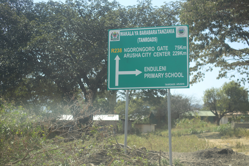 A sign stands near Endulen Primary School in Tanzania's Ngorongoro Conservation Area. The government has demolished schools, homes and health facilities while pressing Maasai families to leave their ancestral land in the name of wildlife protection and tourism. (GSR photo/Doreen Ajiambo)