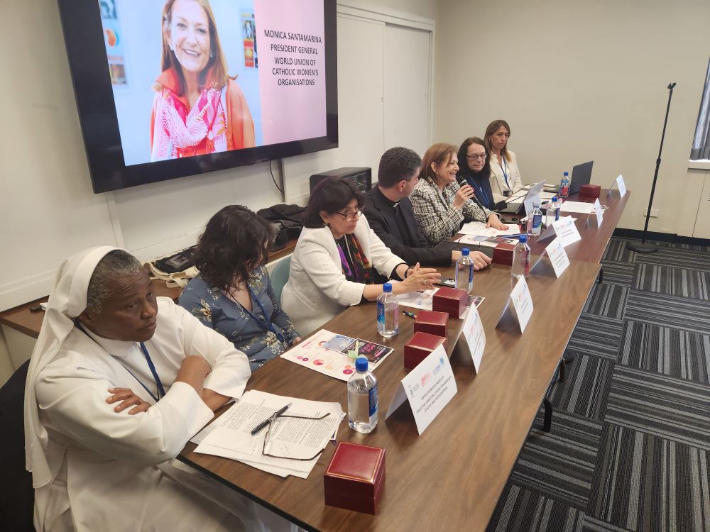 Sr. Ngozi Frances Uti sits at table with others during event at UN. 