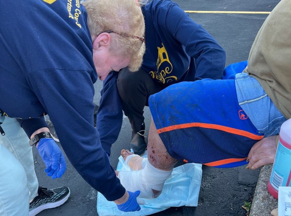 Sr. Mary Meyers bandages the foot of a patient at Project Hope in Wheeling, West Virginia. She works on Pittsburgh's Duquesne University campus during the week and volunteers on weekends, providing health care for those in need. (Courtesy of Mary Meyers)