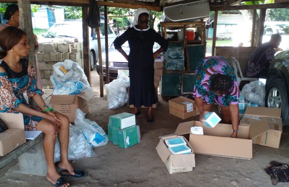 Sr. Justina Suekime Nelson and others organize supplies. 
