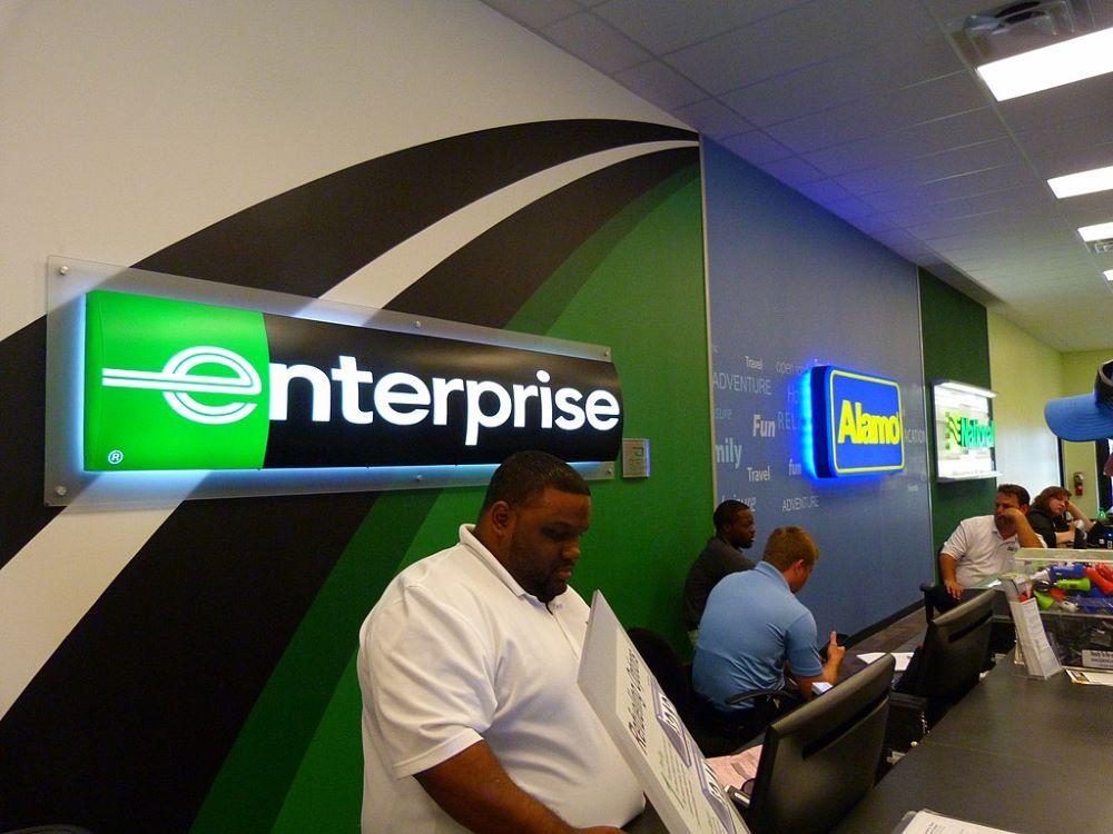 Staff work at a car rental counter for companies including Enterprise and Alamo. (Wikimedia Commons/CC Attribution 2.0 Generic/Rusty Clark)