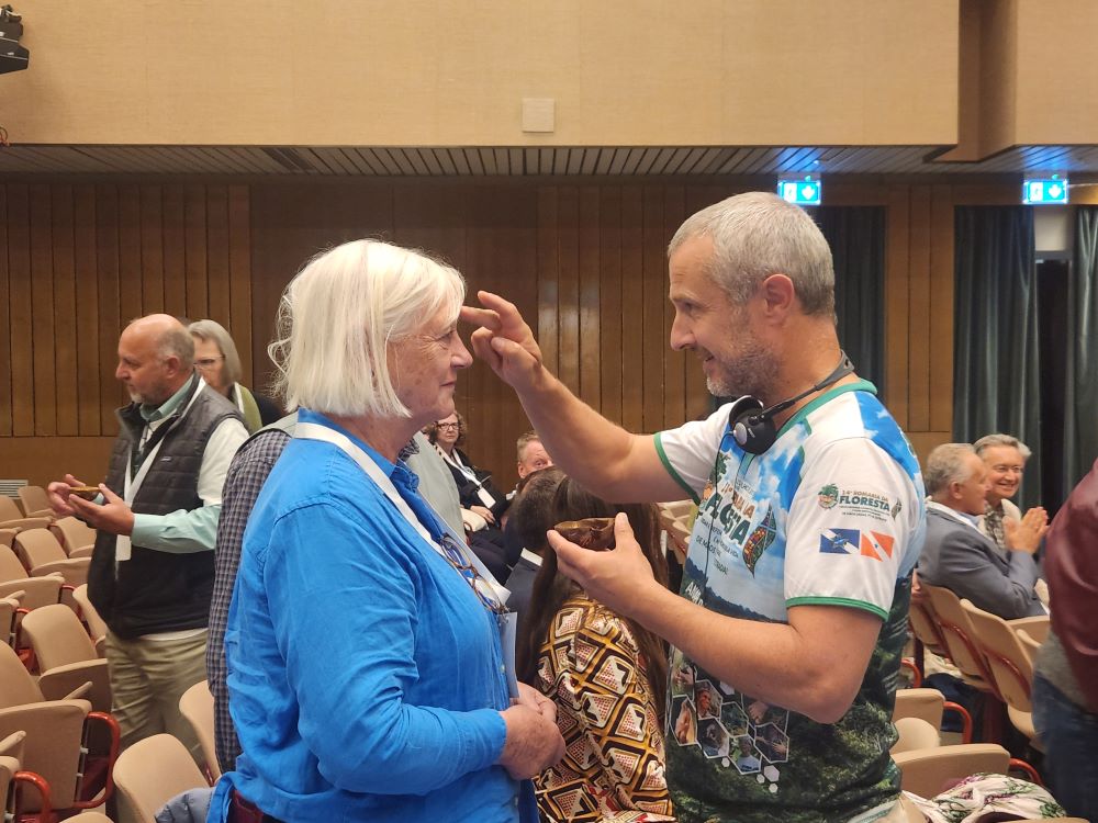 Conference attendees bless each other with water. 