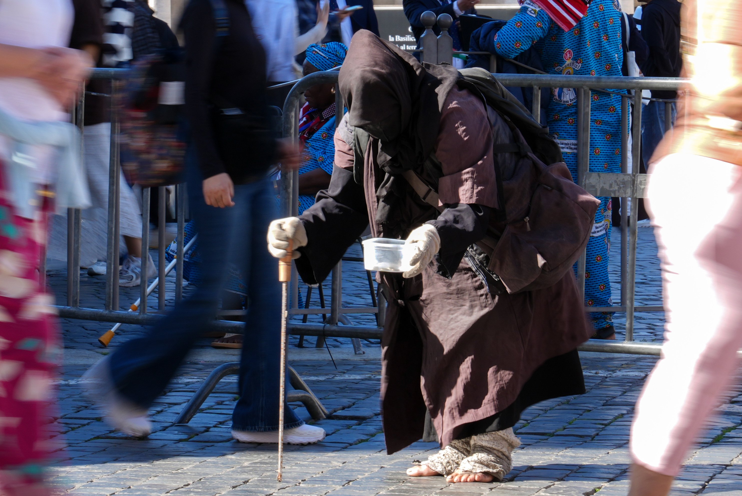 A person asks for alms near St. Peter’s Square at the Vatican Oct. 8, 2025. (CNS photo/Lola Gomez)