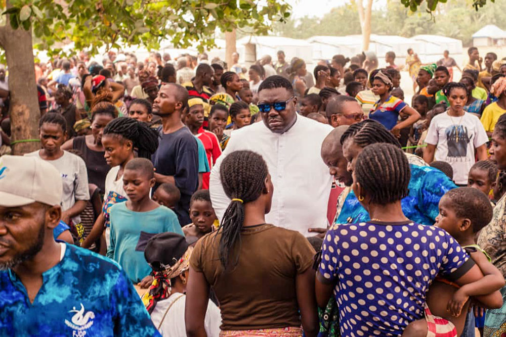 Fr. Remigius Ihyula accompanies internally displaced persons at the Uikpam camp in Benue State, Nigeria. Since 2017, Ihyula has responded to Benue's worsening humanitarian crisis, making the camps his second parish and offering pastoral care and counseling to traumatized survivors. (John Chukwu)