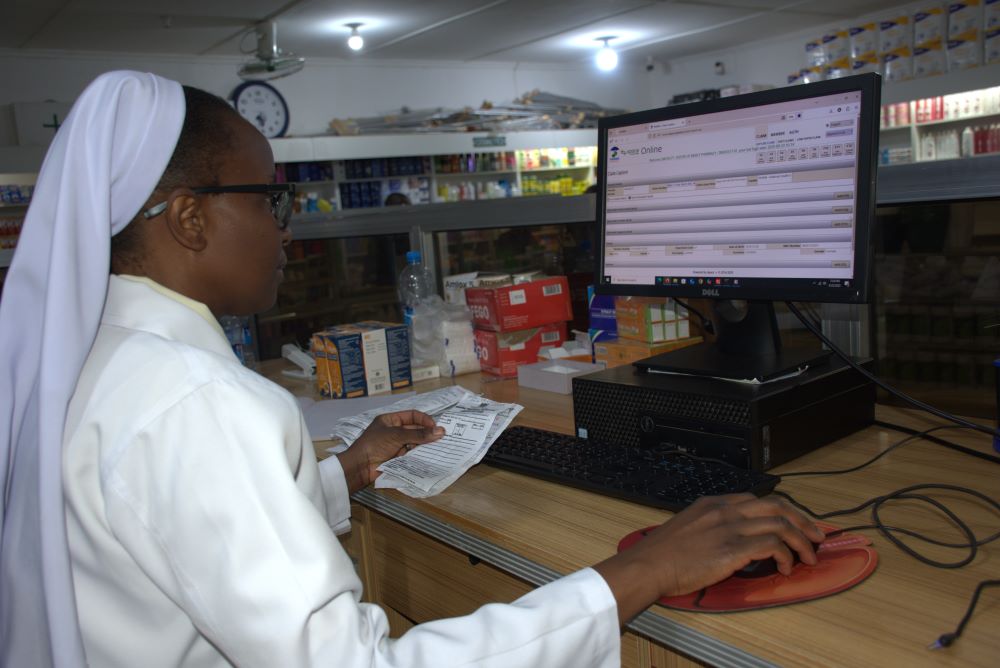 Sr. Audrey Chungu works at a computer in her office. 