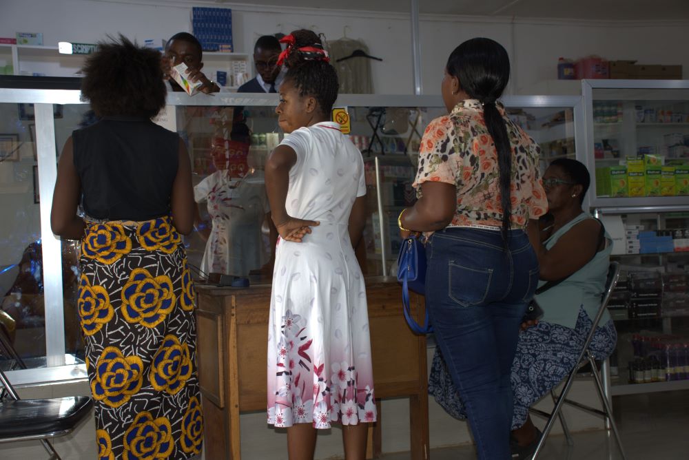 Patients wait to pick up medication prescribed at public hospitals at the Sisters of Mercy Pharmacy in Mansa, Zambia.