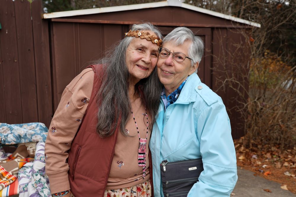 Tribal Elder Tinker Schuman and Sr. Marla Lang embrace.