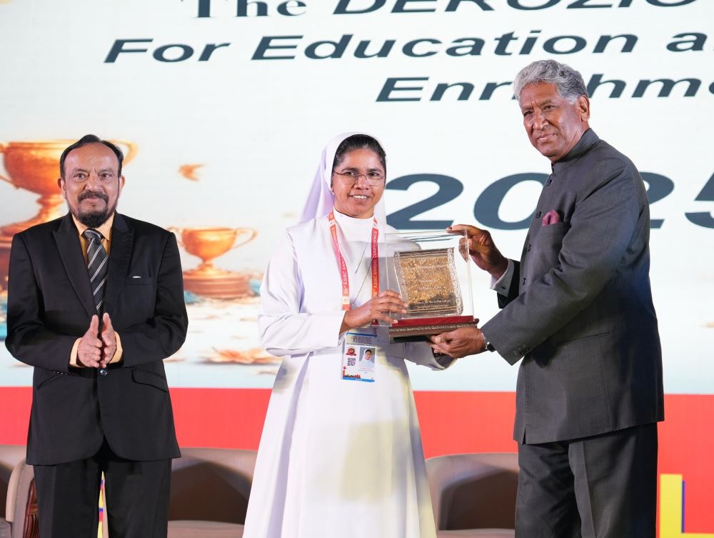 Salesian Sr. Seena Joseph stands with the Derozio Award.